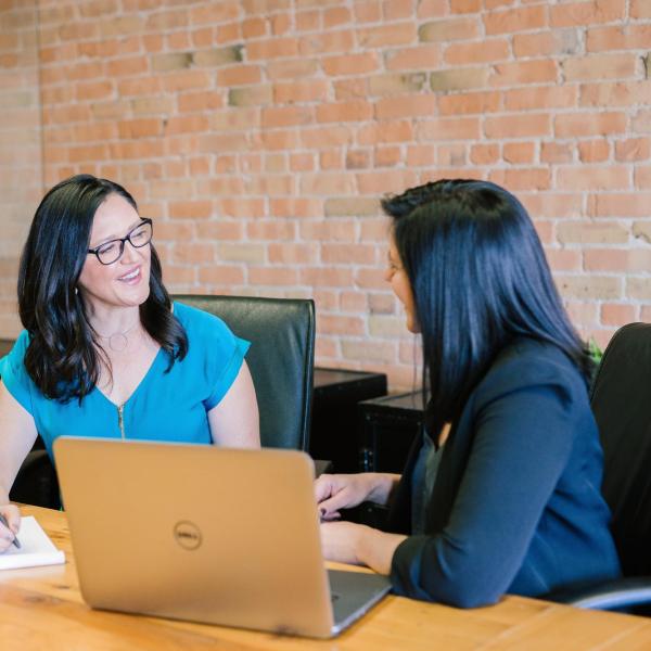 Two women discussing teaching goals