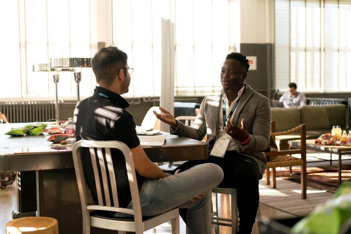 two people chat in a coffee shop