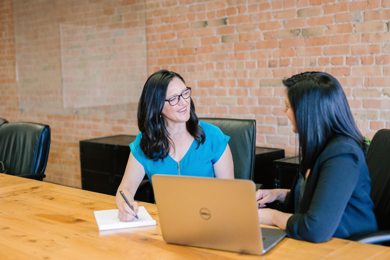 Two women discussing teaching goals