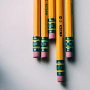 Pencils rest on a notebook