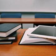 lecture hall with books and a laptop on a desk