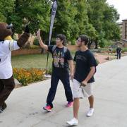 CU Mascott high fives a CU Boulder students on move in day