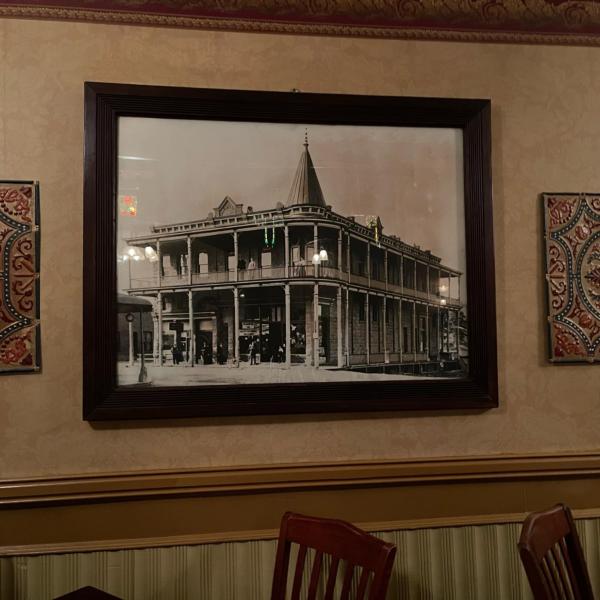 A black and white historic photo of the Weatherford Hotel hangs in the hotel lobby.