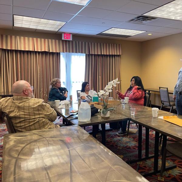 Lavern Owl speaks with the research team in a hotel conference room in Flagstaff, Arizona. Zane Grey expert and descendent of the Wetherhills of Kayenta, Harvey Leake, looks on while Cultural Resources Program Manager of the Zane Grey House museum, Alex Garcia-Maldonado, listens along with Ashlyn Barnett and Tamar McKee with the CAW.