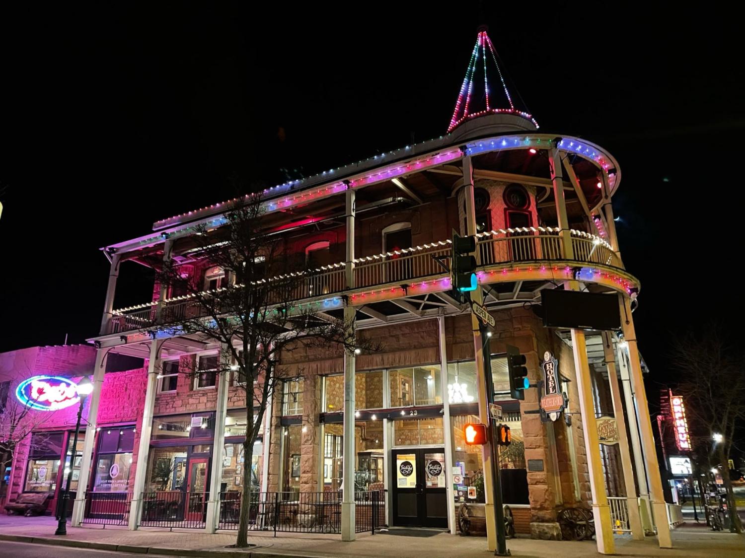 The Weatherford Hotel in Flagstaff, Arizona, glows at night with strings of lights of various colors.