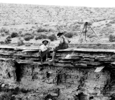 2 miners resting on the side of rocks