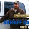 photo of Dave Ward standing in front of sheriff's car