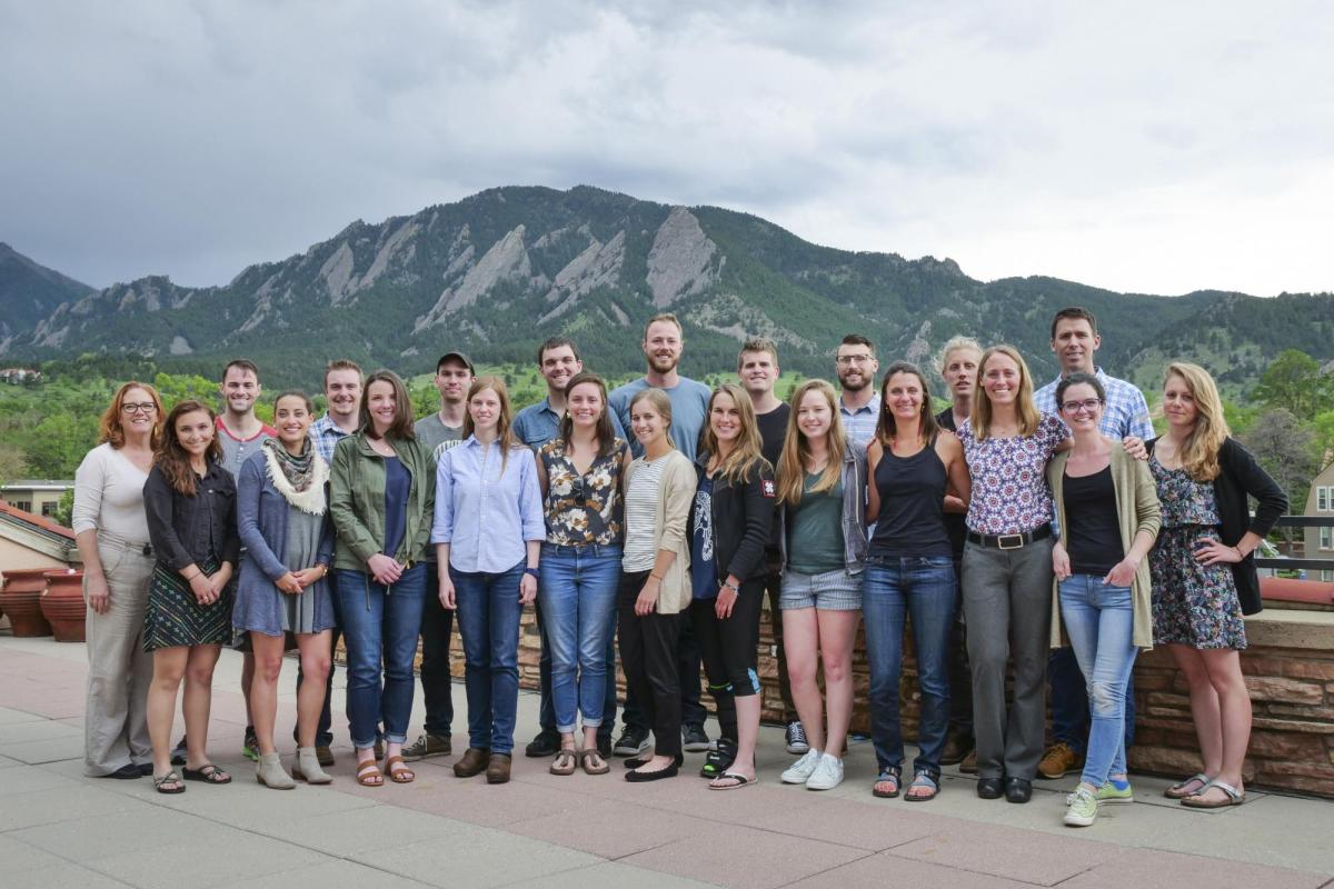 Cohort students standing together in front of a mountain