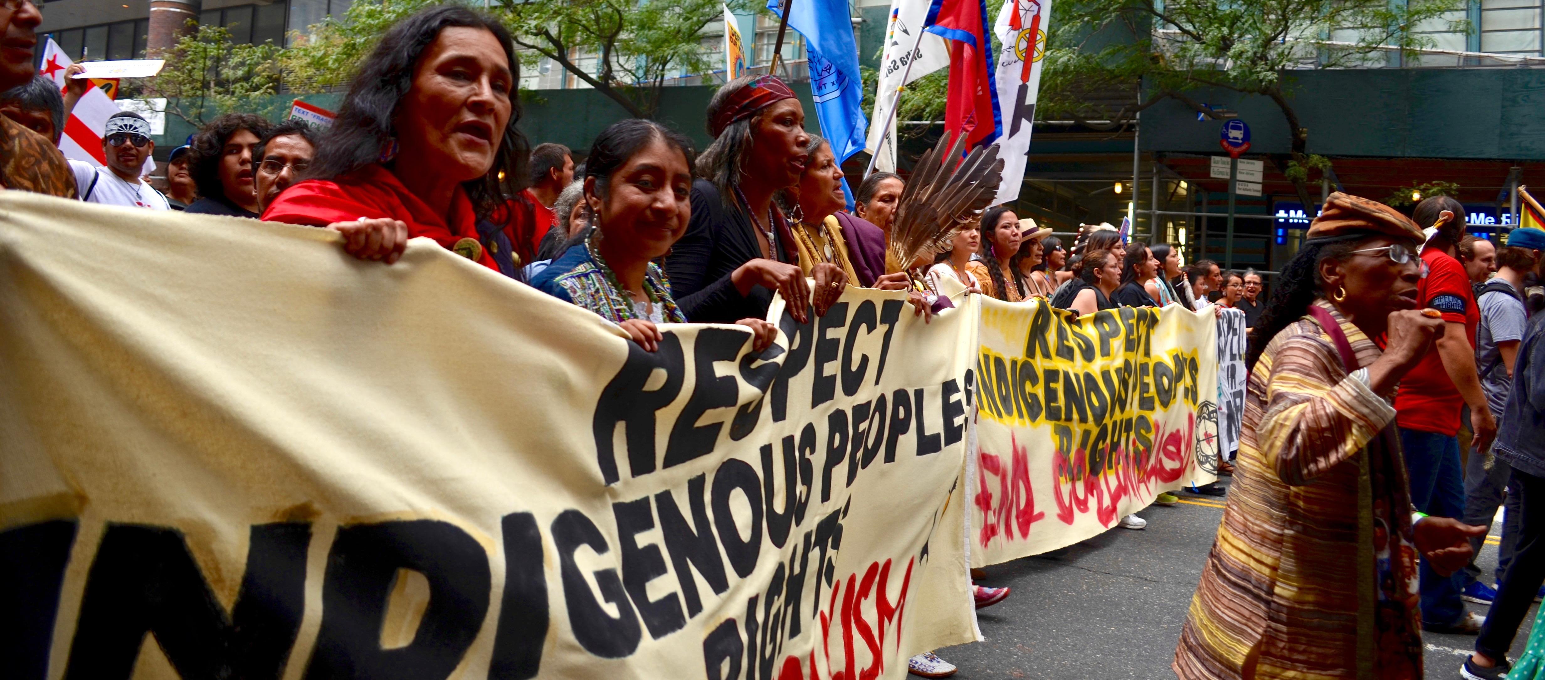 A group marches in the Peoples Climate March holding a banner “Respect Indigenous Peoples' Rights"