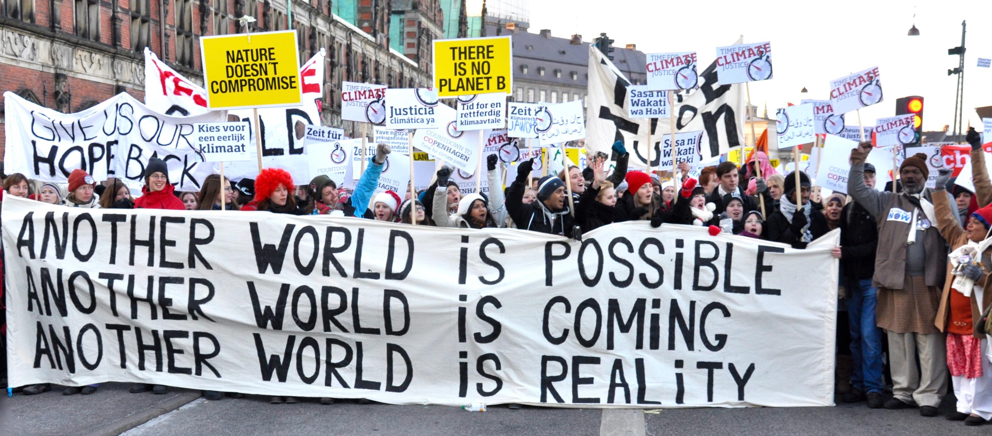 Marchers at the Copenhagen Climate March hold a banner "Another world is possible"
