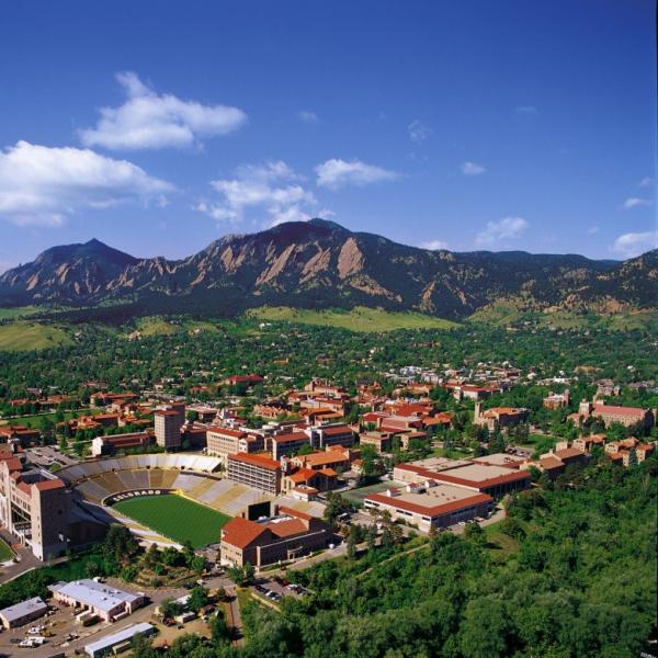 A picture of the University of Colorado, Boulder from above with the Flatirons in the background