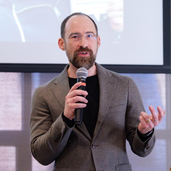 Caleb Elfenbein holding a microphone