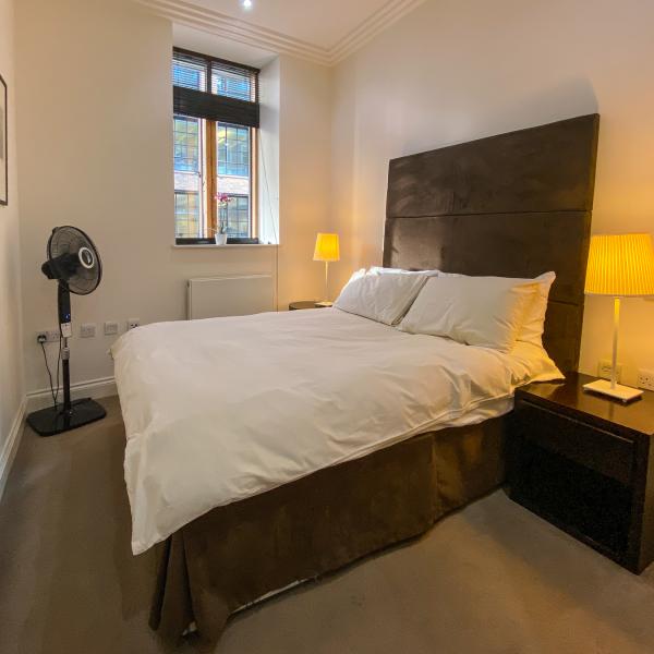 Bedroom with queen sized bed and window