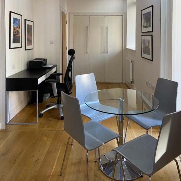 Dining room table and office room in background