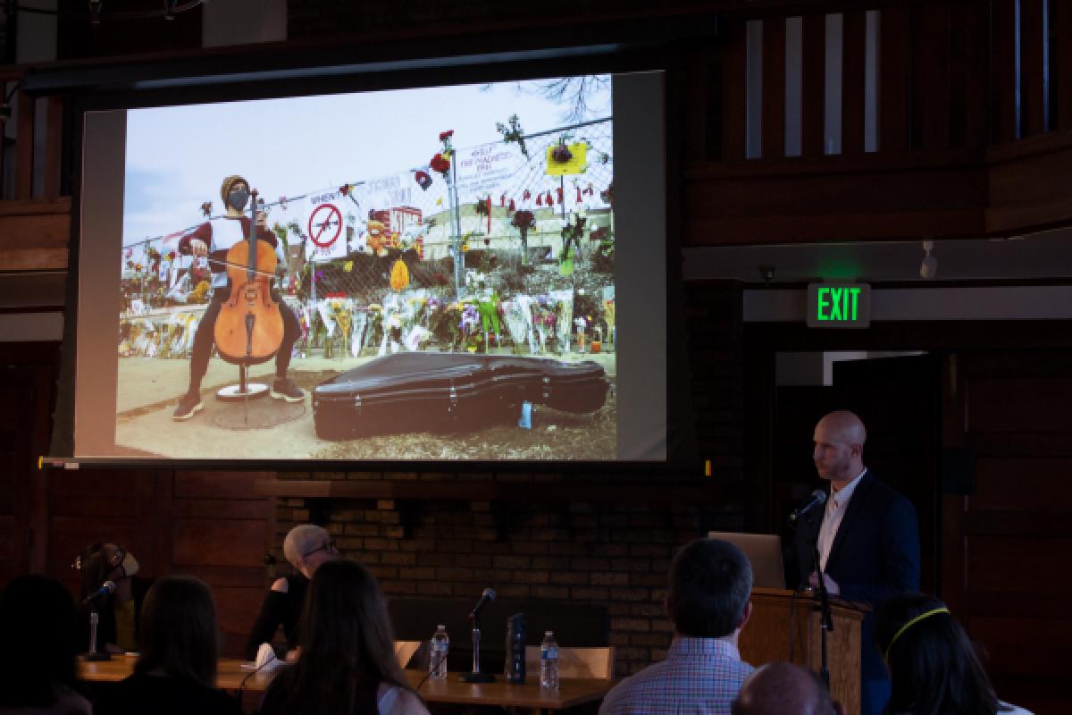 Projection screen showing a person playing the cello