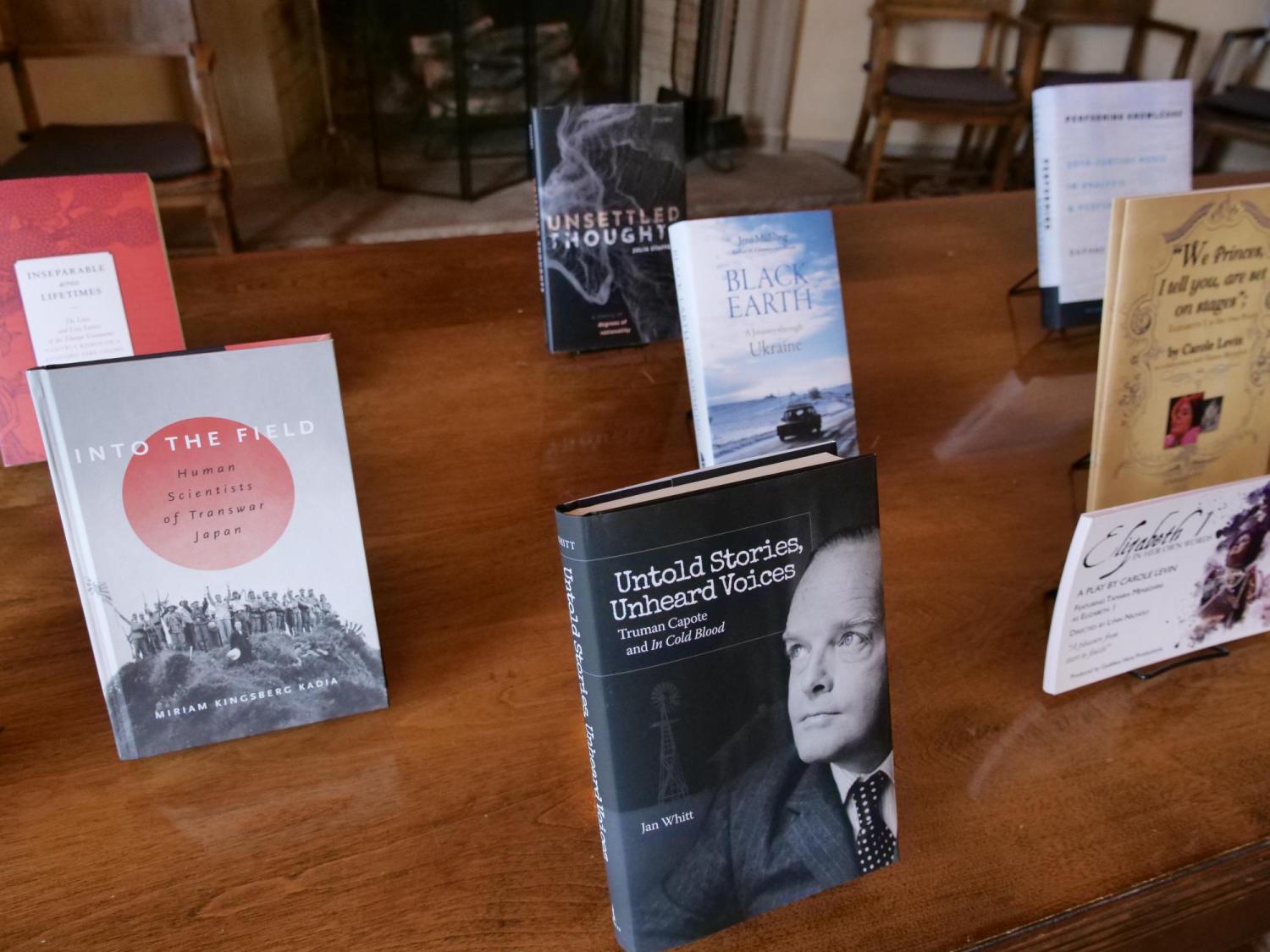 Faculty work displayed on a table in Norlin Library