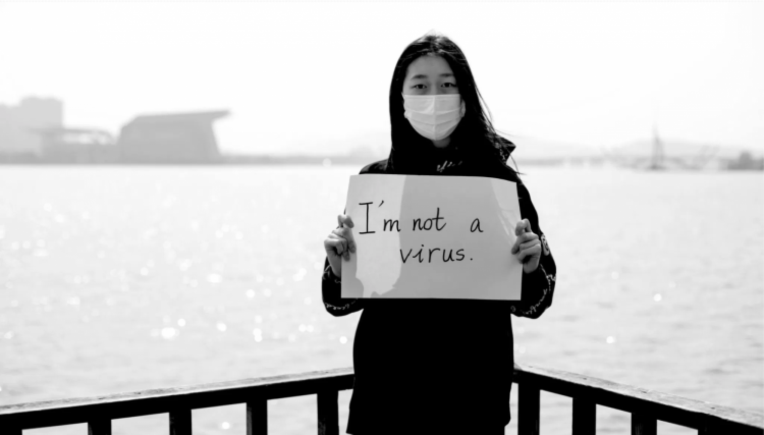 women standing holding a sign