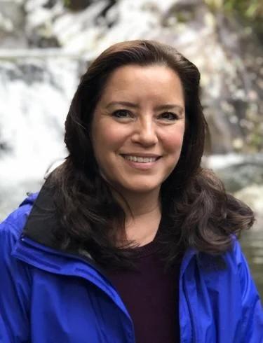 Angelica Lawson smiling and wearing a blue jacket