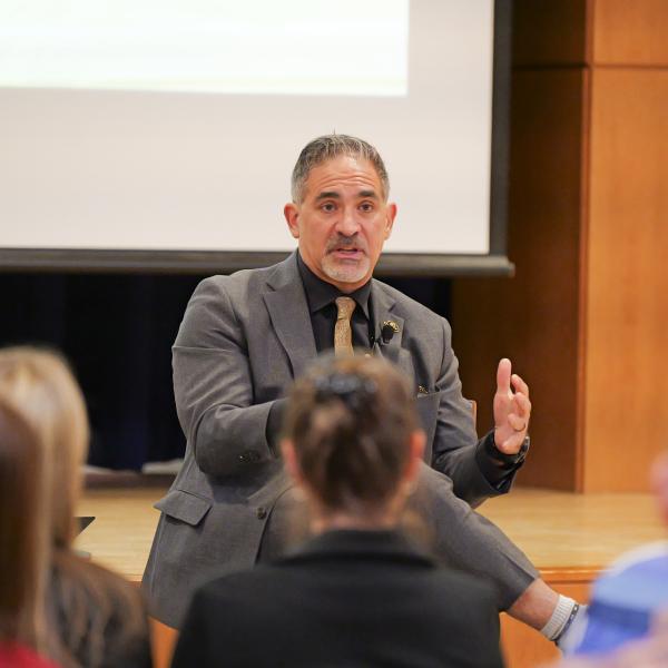 Justin Schwartz addressing a room of people