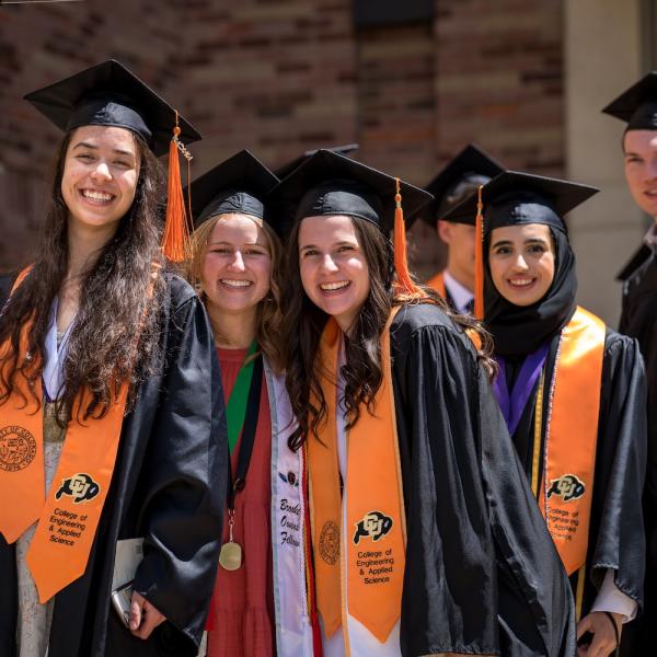 ChBE graduates pose in cap and gown in 2022
