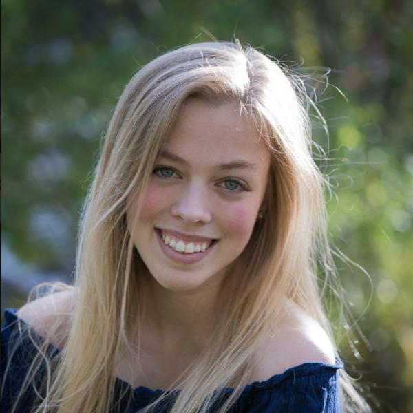 Anna Broerman with blurred trees in the background.