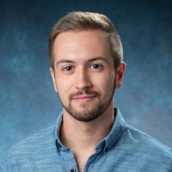 Hector Sanchez-Moran in blue shirt against blue background