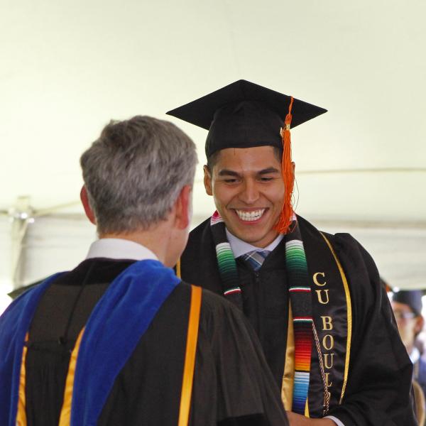 Student crosses graduation stage.