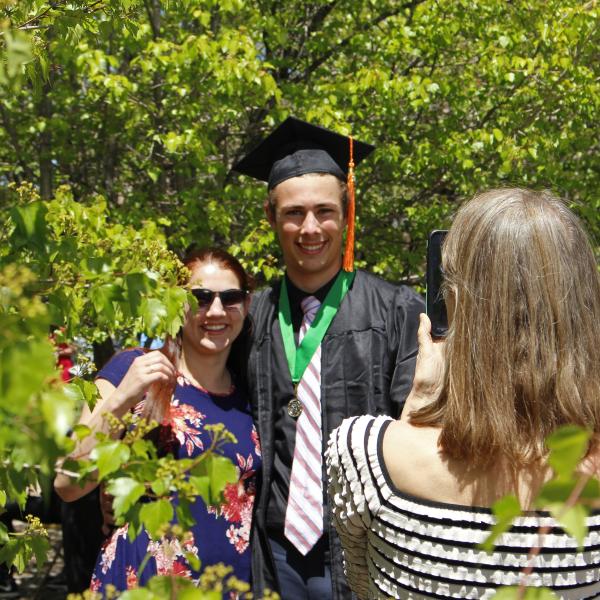 Students pose for photos at department graduation ceremony.