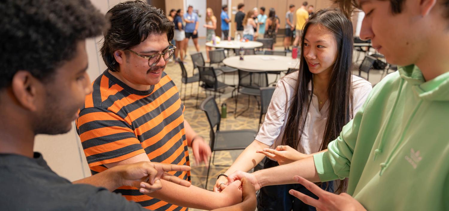 BOLD students stand in a circle holding hands in the middle.