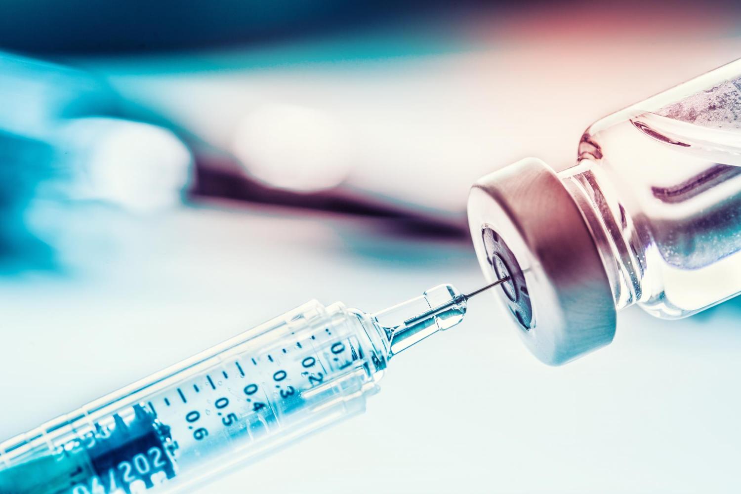Syringe drawing a vaccine