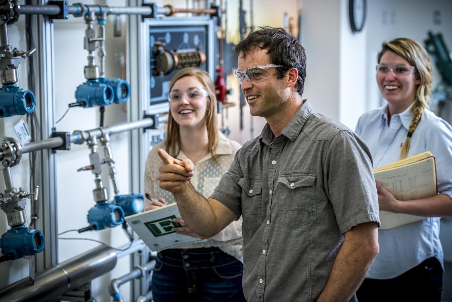 Instructor in lab with two female students