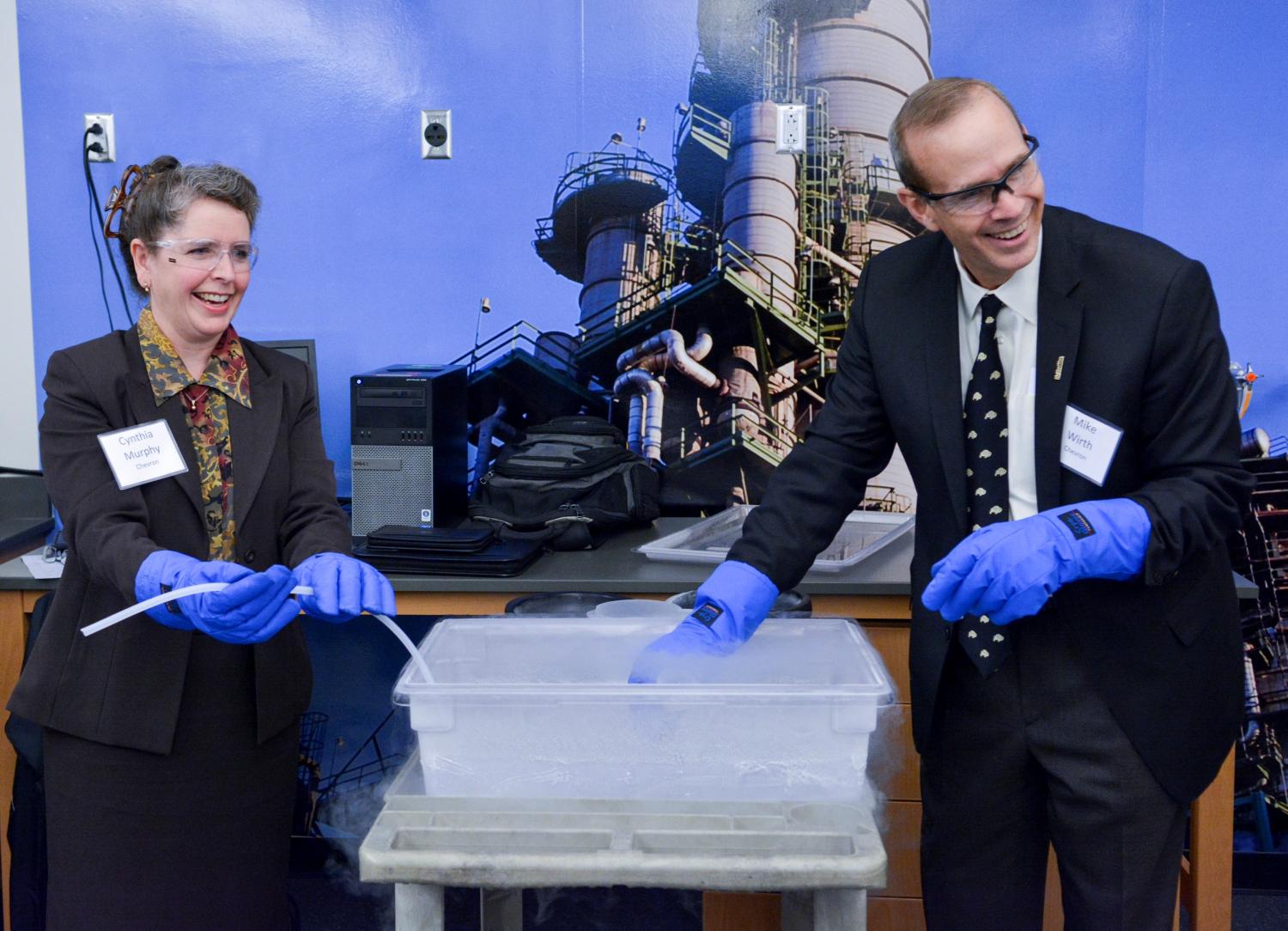 Cynthia Murphy and Mike Wirth of Chevron use liquid nitrogen to freeze tubing
