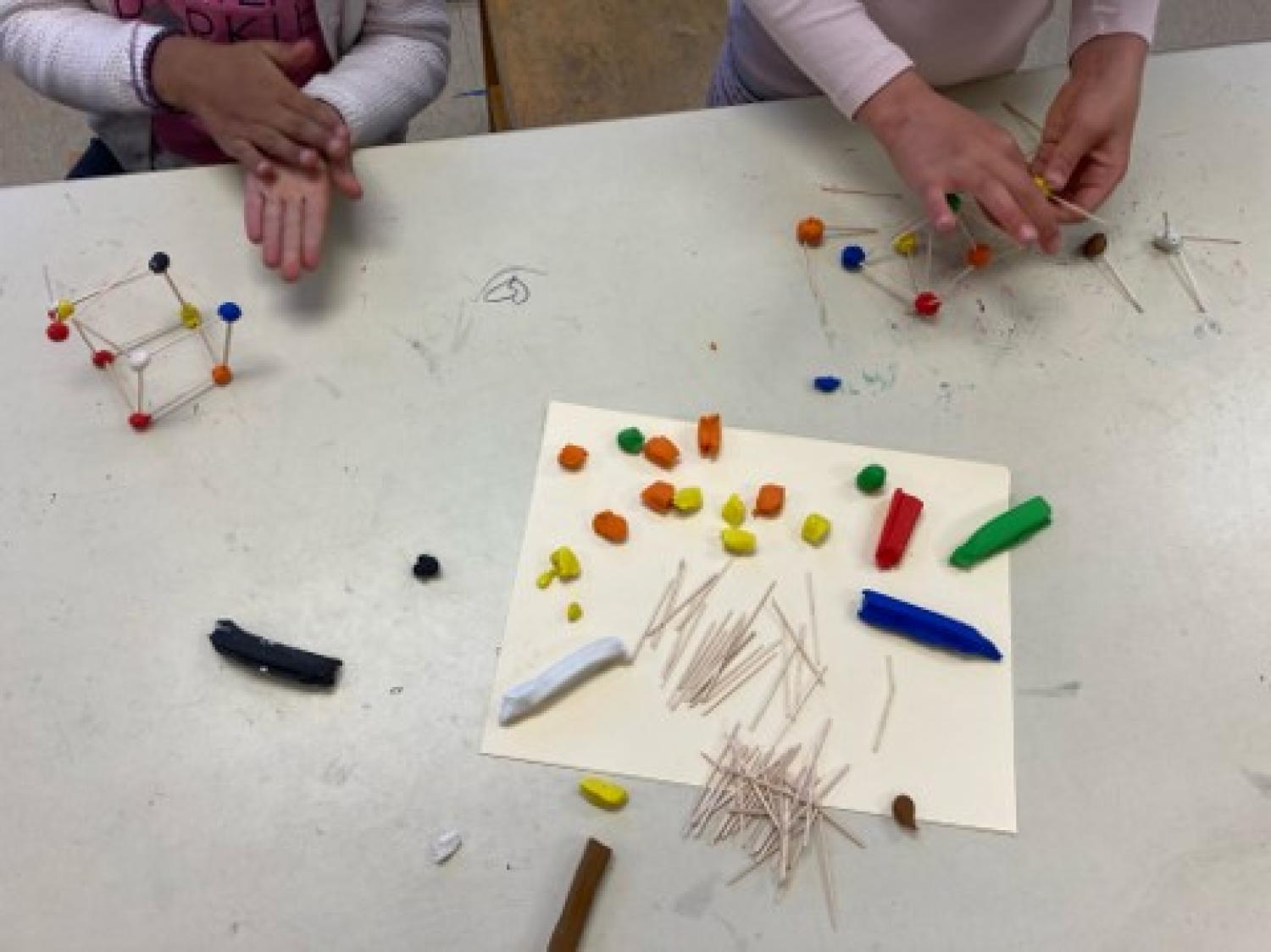students working with hands-on art projects to learn about science concepts