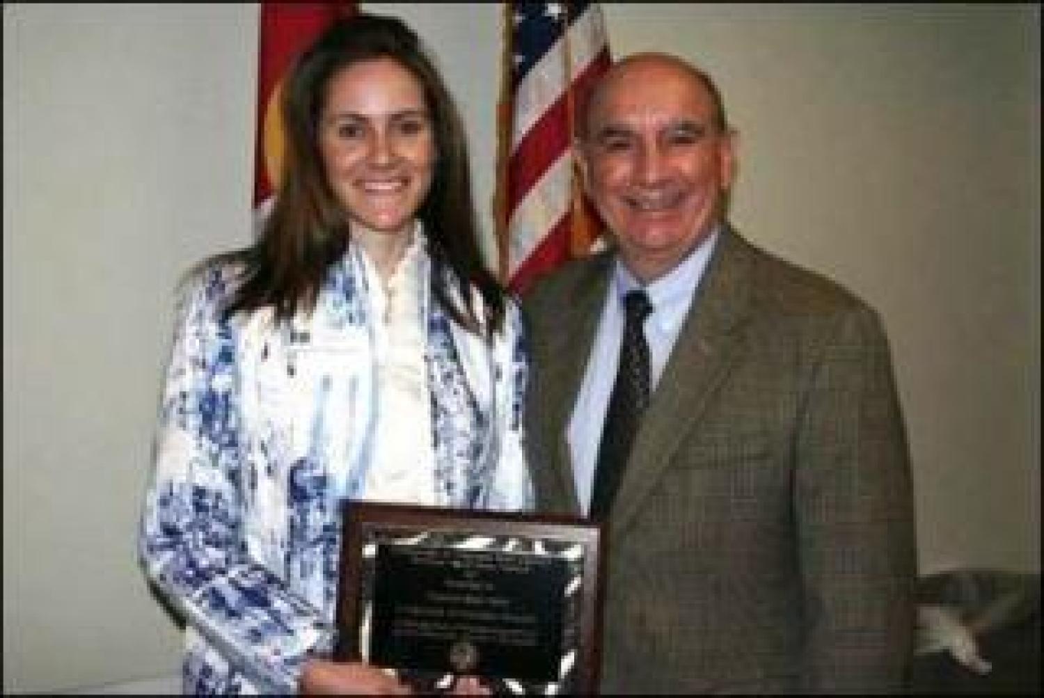 Frannie Ray Earle receives award from chancellor Phil DiStefano.
