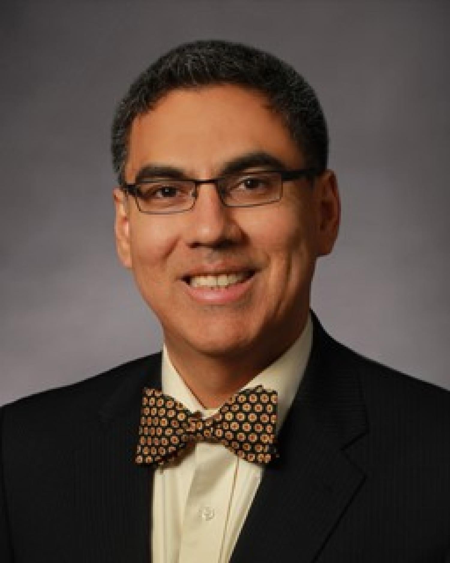 Gomez in suit and bow tie