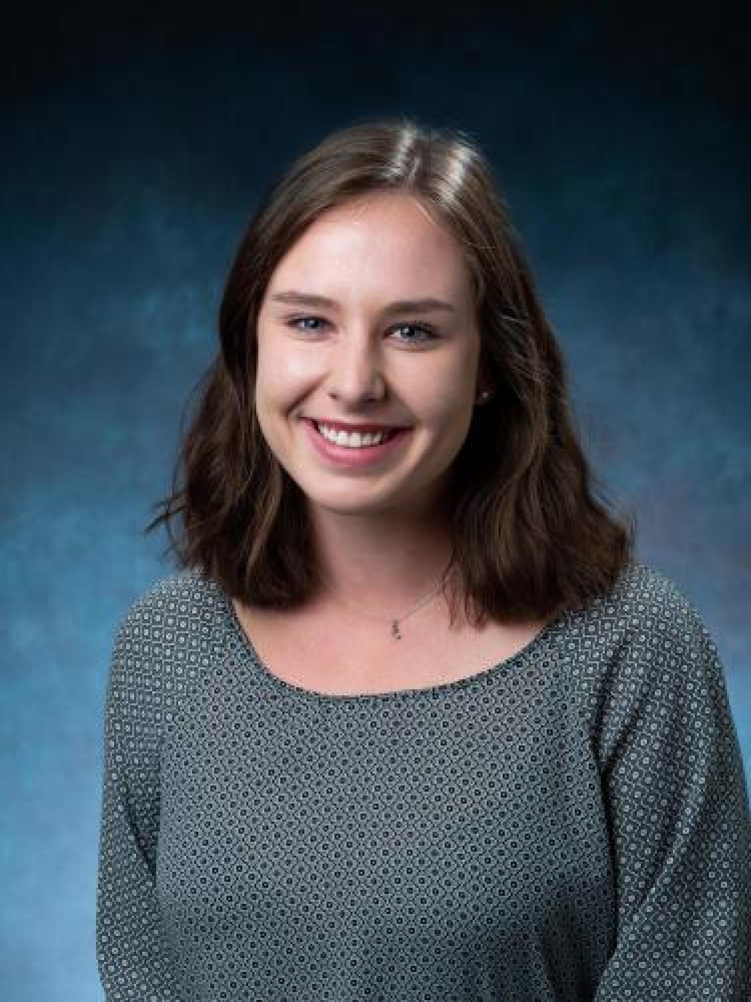 Nicole Day in blue shirt with blue background