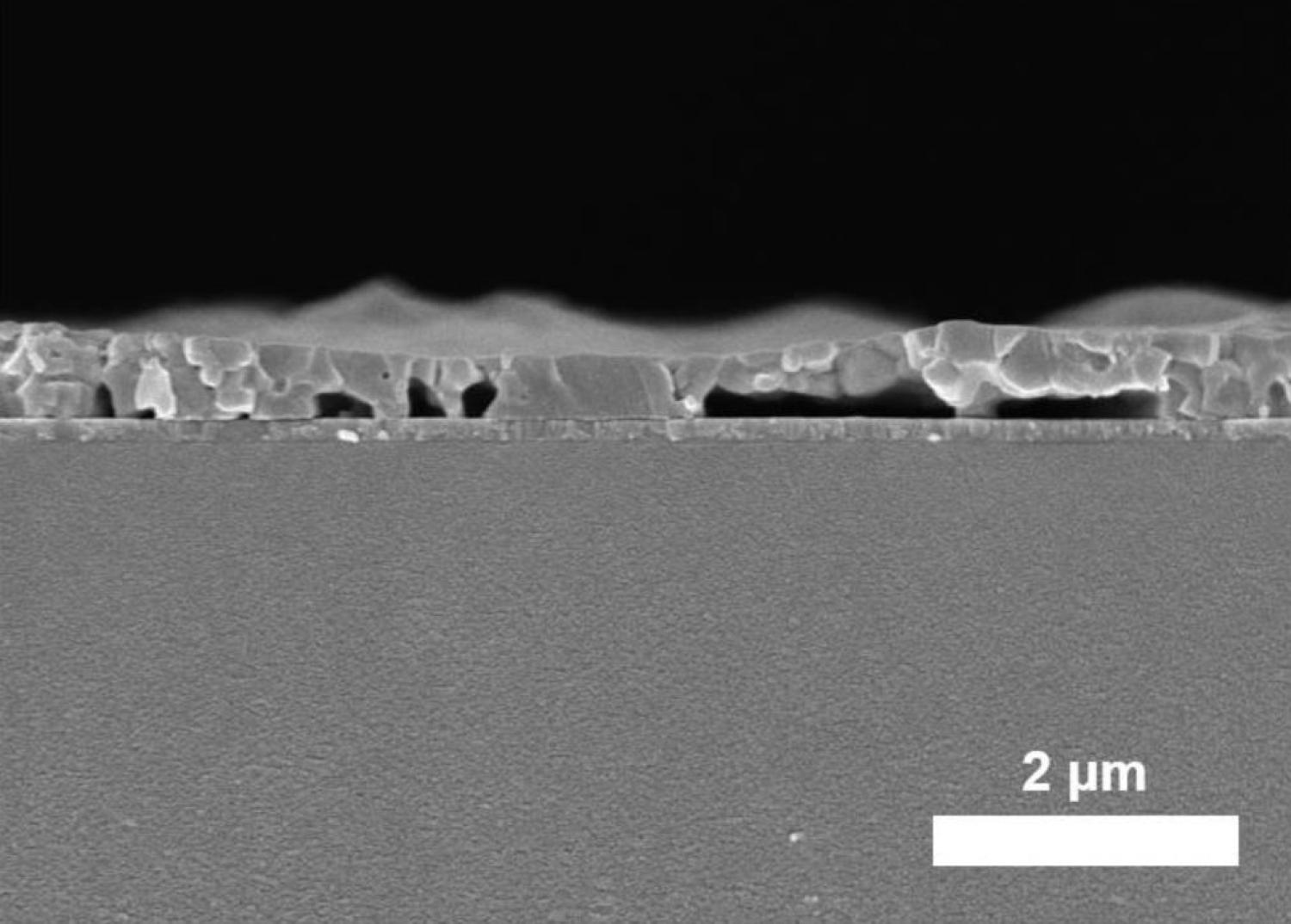 Cross-sectional SEM image of the spin-coated MAPbI3 film processed from DMF precursor solution (annealed for 5 s at 100 °C) on a PTAA-covered ITO glass substrate.