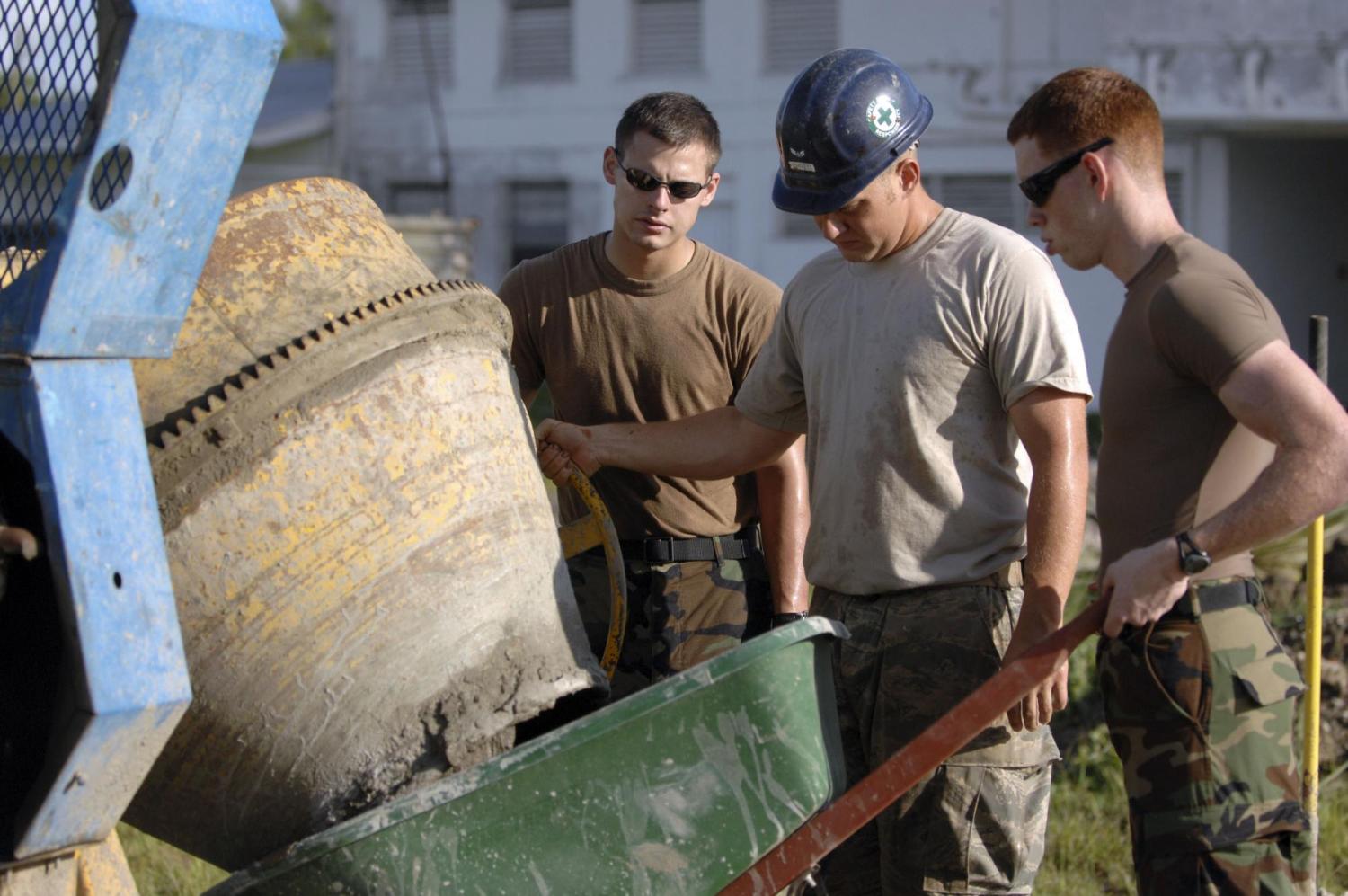 US Navy workers mix cement