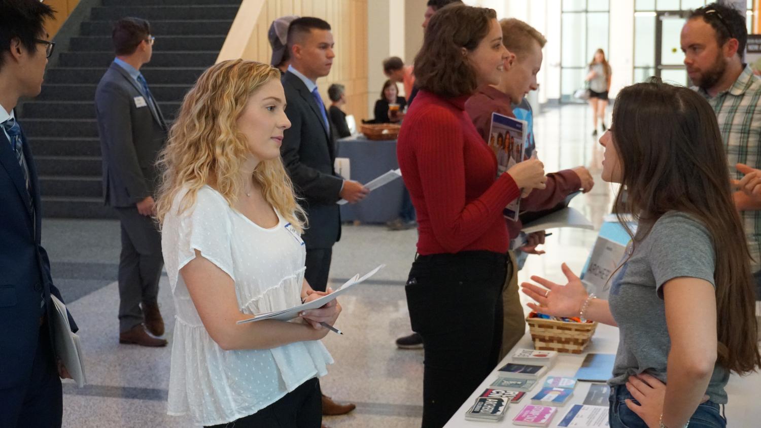 Student talking to industry recruiter at a career fair