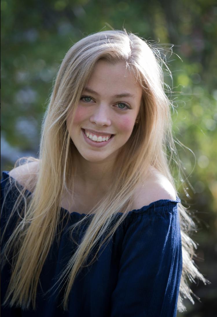 Anna Broerman with blurred trees in the background.