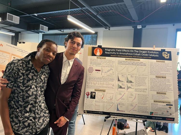 Barrientos and another unidentified student stand in front of a poster at the Caltech Final Summer Research Symposium.
