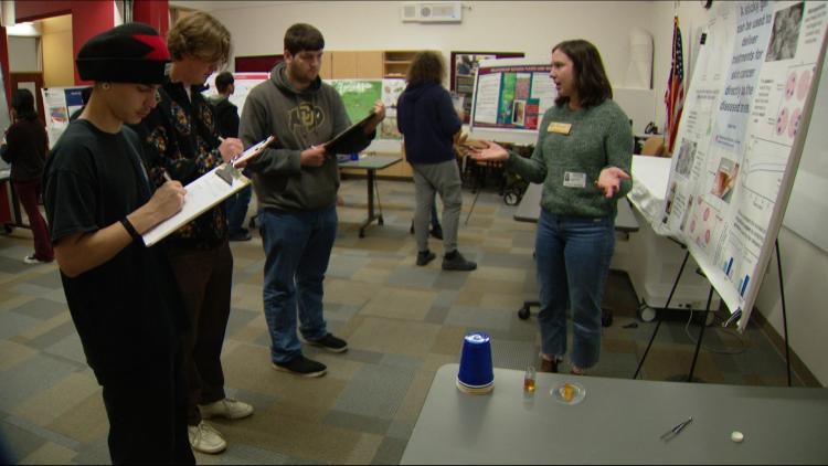 PhD Student Nicole Day presents her research at the Reverse Science Fair.