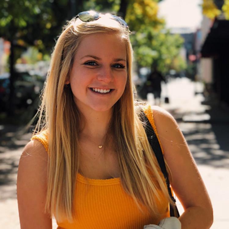 Emma Aoueille wearing orange shirt
