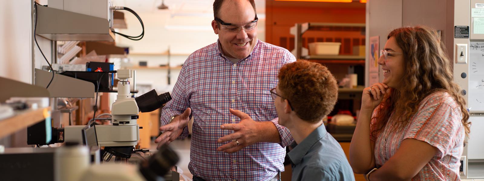 Professor White works with students in the lab
