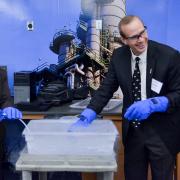 Cynthia Murphy and Mike Wirth of Chevron use liquid nitrogen to freeze tubing