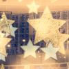Gold stars hang from a ceiling