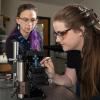 Konane Bay oversees a student using equipment in the Huli Lab