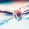 Syringe drawing a vaccine