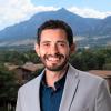 Brian Aguado in grey suit with Flatirons background
