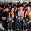 Graduates pose with their diplomas